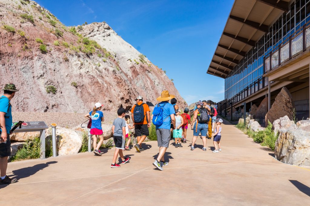 Jensen, USA - July 23, 2019: Exterior Quarry visitor center exhibit hall in Dinosaur National Monument Park with people tour group walking in Utah