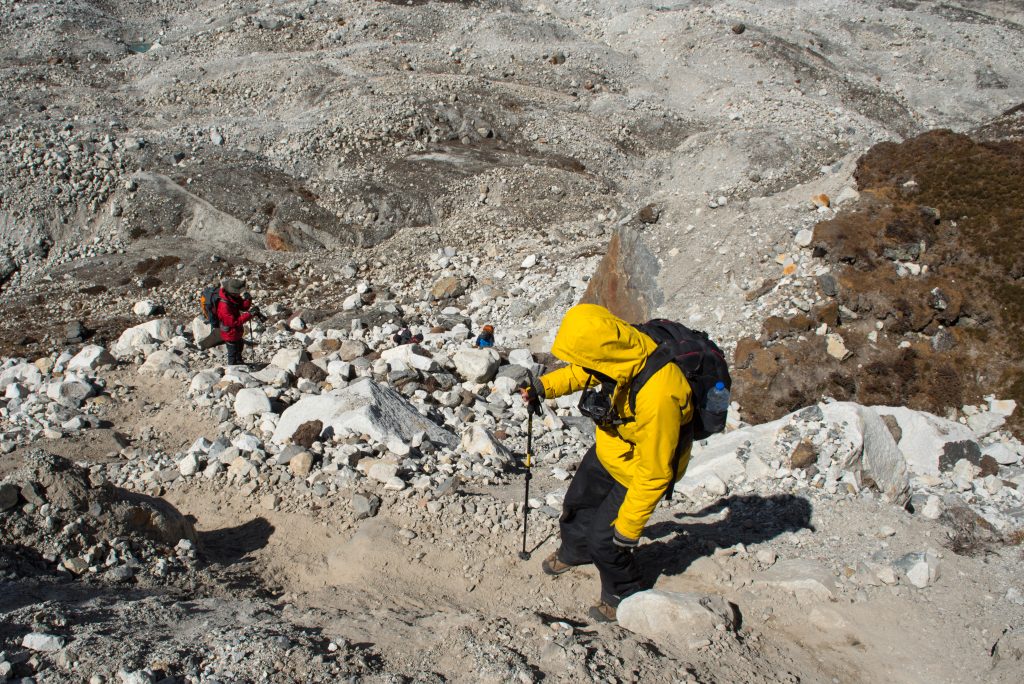 Trekker walk down to glacier on the way to Gokyo village in Everest base camp trek route region,Nepal.